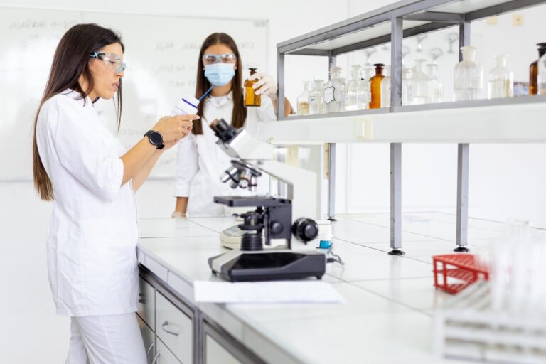 Scientists working at multi-level lab bench