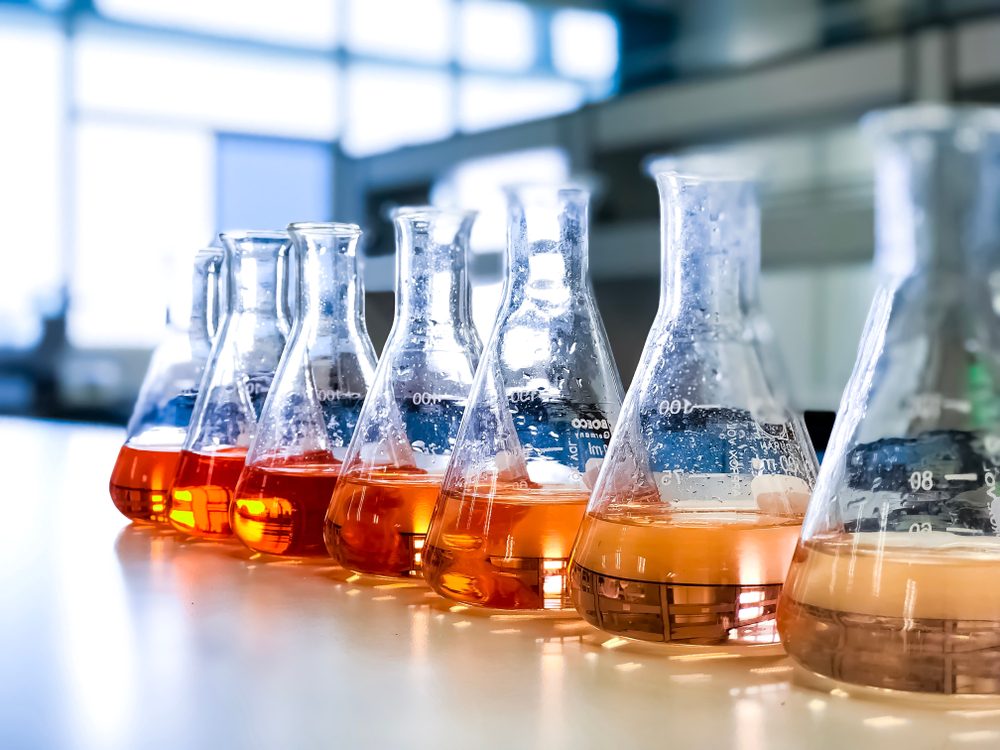 Conical flasks with hazardous chemicals on lab bench