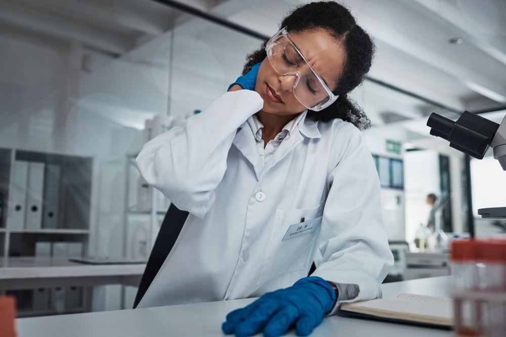Scientist with neck pain in a laboratory 
