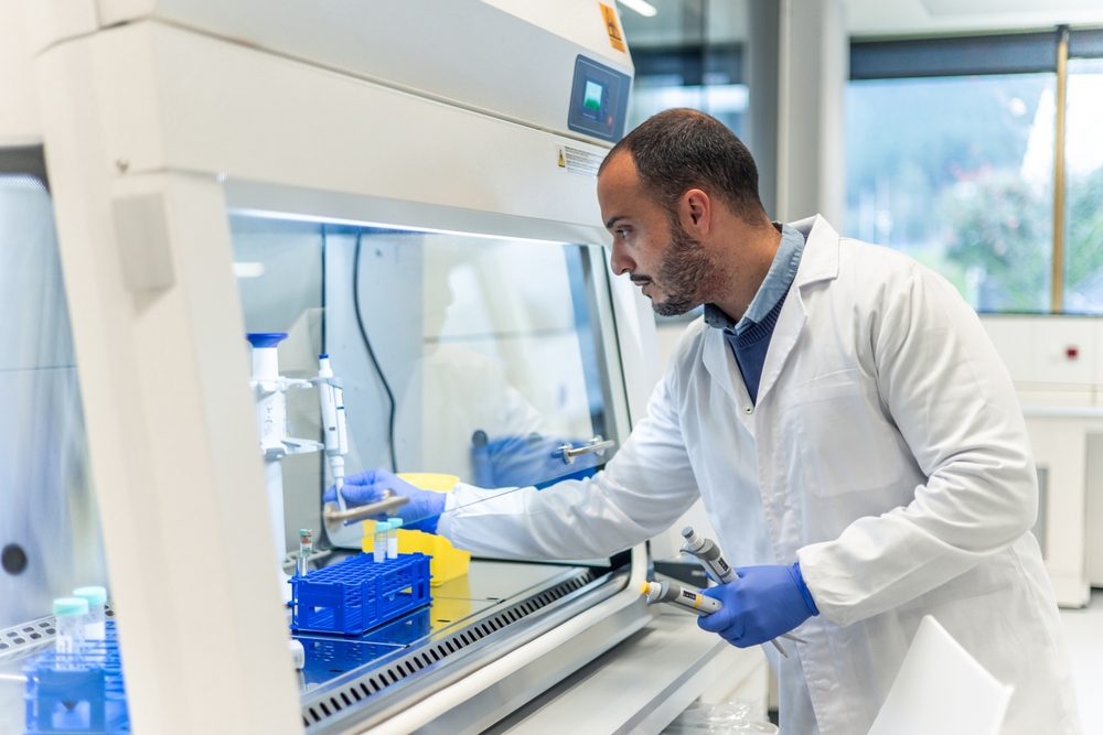 Scientist working under fume hood in modern research laboratory 